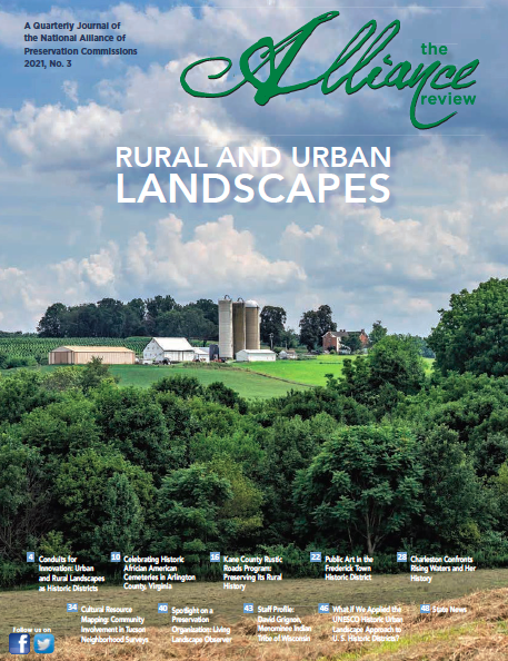 View of a farm in rolling hill son the cover of the Alliance Review journall